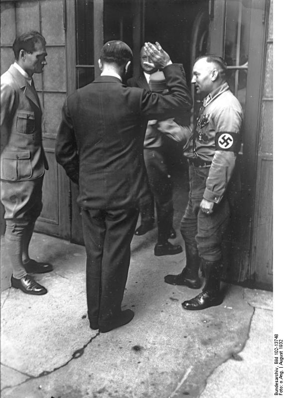 Adolf Hitler greets some Party members in Neubiberg